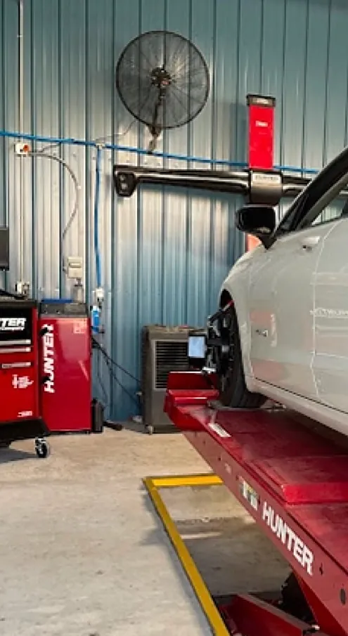 The red Hunter alignment console and lift inside the Paul's Auto & Collision shop